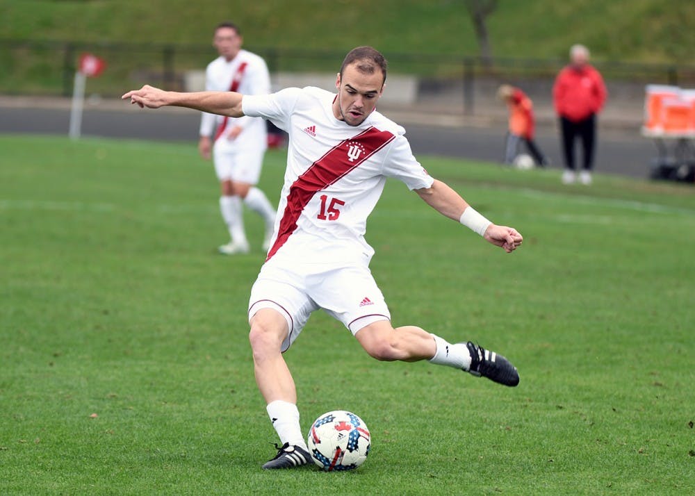 <p>Then-junior defender Andrew Gutman kicks the ball against Ohio State on Oct. 15 at Bill Armstrong Stadium. Gutman was named a preseason First Team All-American on Monday.</p>