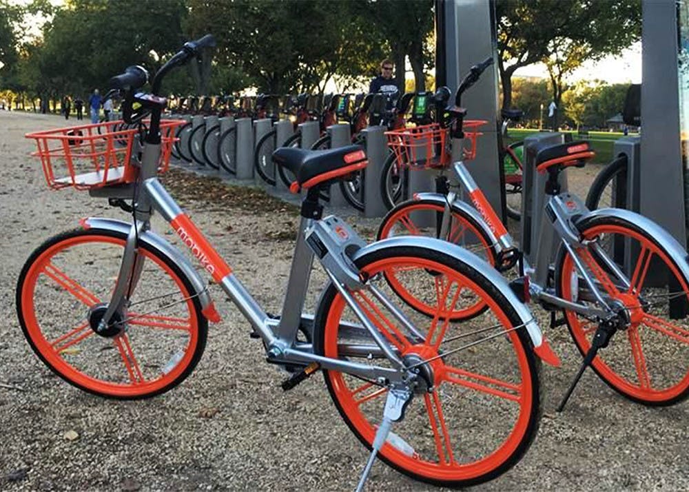 <p>Dock-less bikes park next to a docking station for Capital Bikeshare, in Washington, D.C. Bloomington city officials will work with South Bend, the first city to implement a dock-less bikeshare program in Indiana, as it works to create a bikeshare program in Bloomington.</p>
