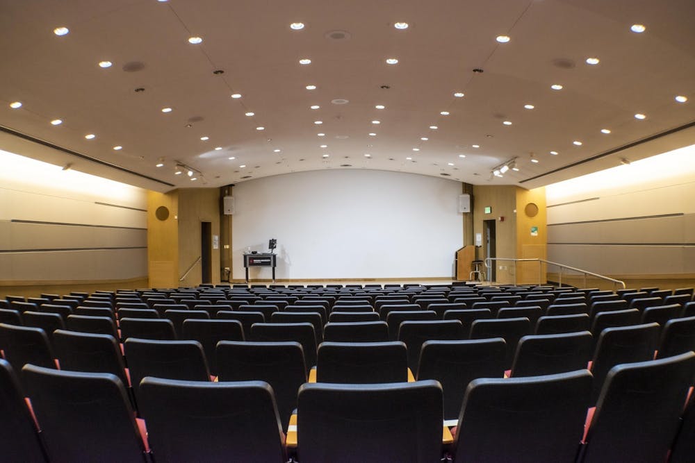 <p>Lights shine on rows of empty seats Sept. 20 in a lecture hall in the Fine Arts Building. A recent study conducted by IU researchers found that students who took more in-person credit hours were less likely to test positive for COVID-19 than other students with less in-person credit hours.</p>