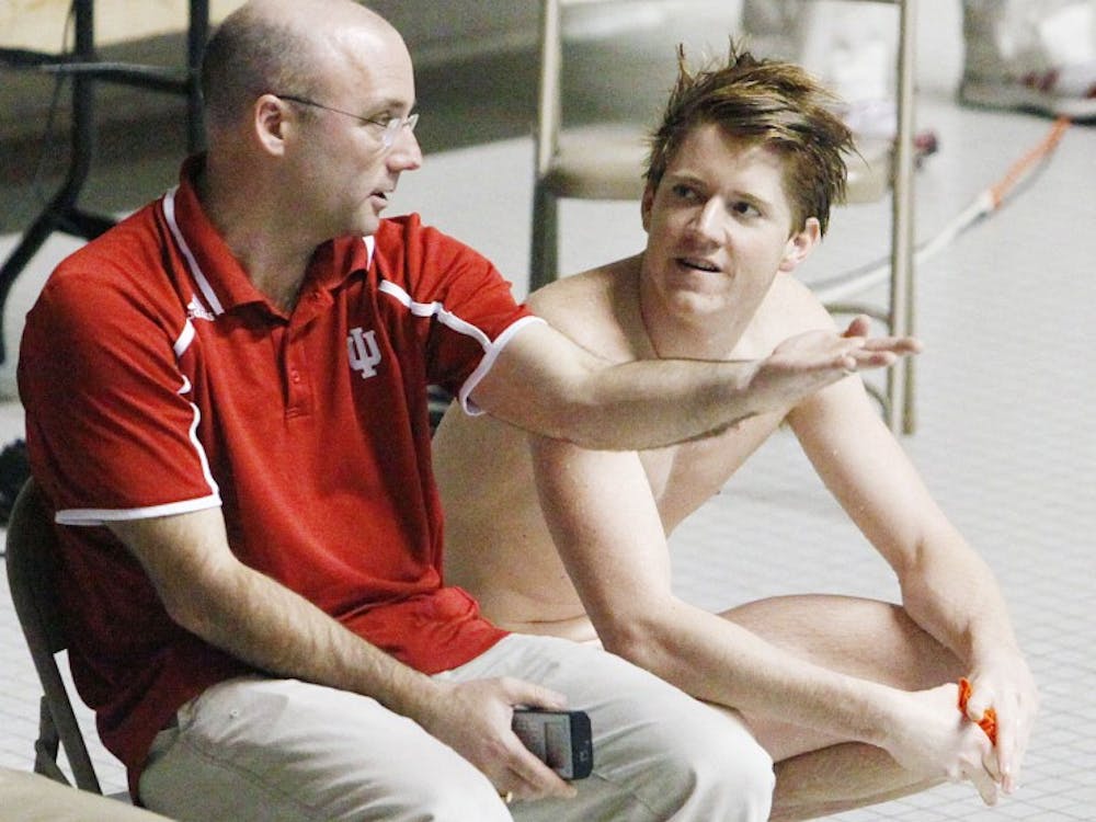 Head Coach Drew Johansen critiques Conor's dive and offers advice for his next round during the Hoosiers' meet against University of Lousiville on Jan. 31, 2014 at the Counsilman-Billingsley Aquatic Center.