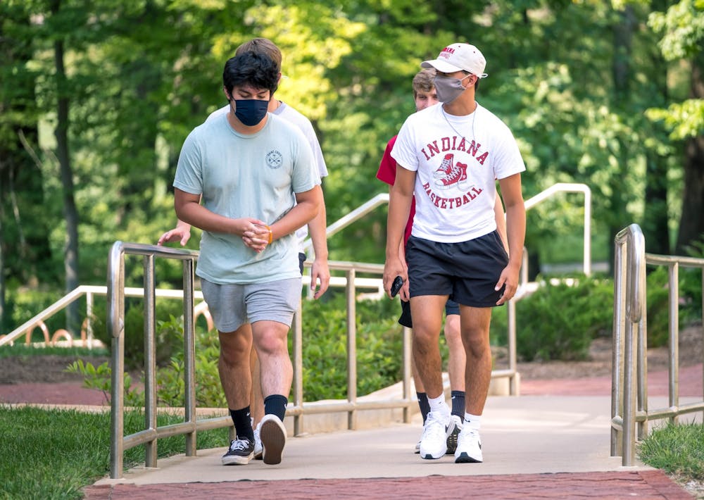 Freshmen students walk through IU to order Starbucks on Aug. 24. The friend group wore their masks together. IU announced Tuesday that mask wearing will be optional for fully vaccinated individuals on all IU campuses effective immediately.
