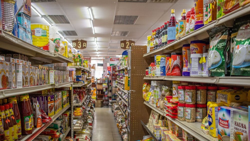 The aisles of Apna Bazaar, an Indian-owned grocery store on Third Street, are shown with products on the shelves. 