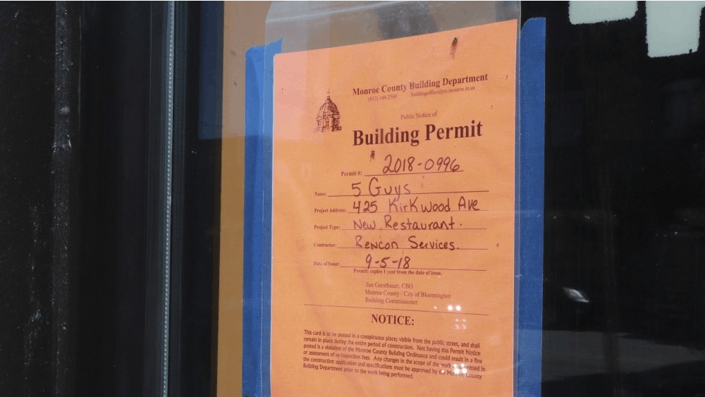 A building permit for the new Five Guys restaurant hangs in the window Sept. 23 at 425 E. Kirkwood Ave.