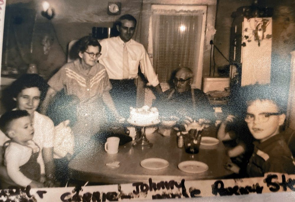 The Stancombe family sits around the dining table in the 1950s. Steve Stancombe, far right, can be seen wearing glasses and looking at the camera.