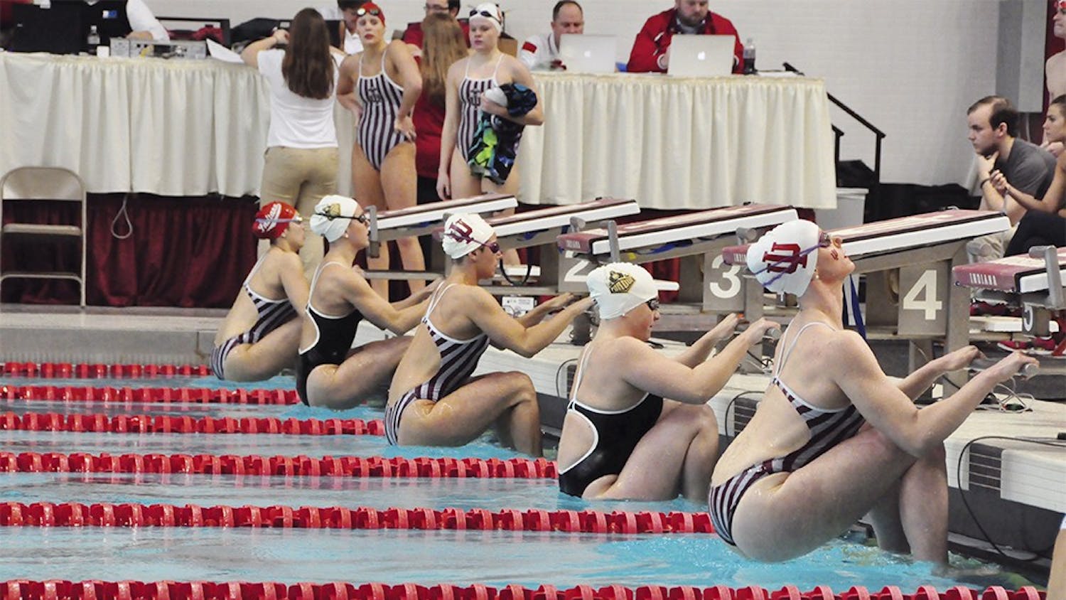 Swimmers from IU and Purdue take their mark during the womens 100 yard backstroke on Satuday. IU Sophomore backstoker Marie Chamberlain won the event with a time of 55.00 seconds. Both the men and women swept Purdue at their last home meet of the season with the men winning 187-107 and the women 185.5-114.5.