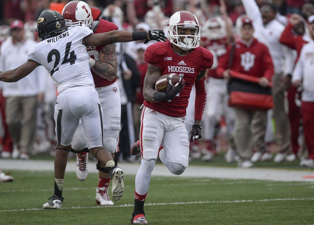Then-senior receiver Shane Wynn watches the screen as he runs for a touchdown in IU's game against Purdue on October 29, 2014, at Memorial Stadium.