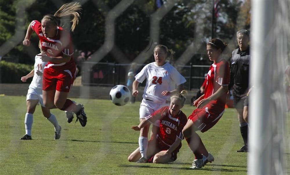 IU defenders Kelly Lawrence, Kerri Krawczak and Kirsta Kellin attempt to catch a loose ball during Indiana’s 1-0 victory over Illinois on Sunday at Bill Armstrong Stadium.