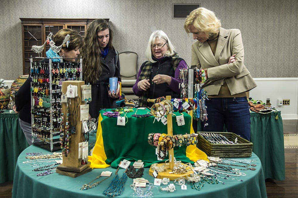 Shoppers look through hand-crafted jewelry at the Fair Trade Holiday Sale in the Indiana Memorial Union on Wednesday. The sale includes hand-crafted gifts from all over the world and will continue today 10 a.m. to 2 p.m.
