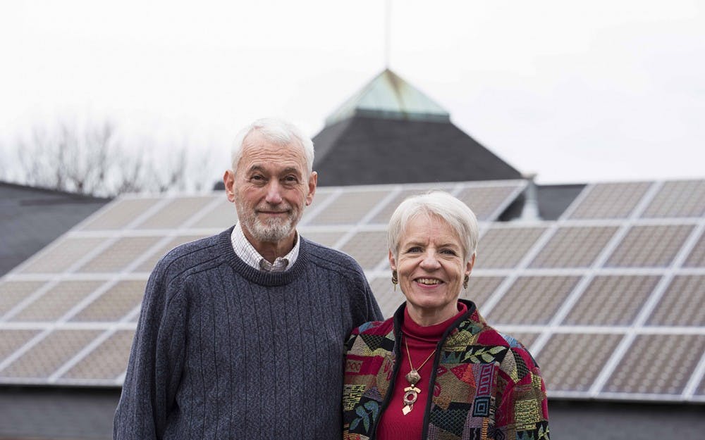 Darrel Boggess and his wife stand in front of St.Thomas Lutheran Church on East 3rd Street. The price of powering the church went from $5000 a month to $1000 after Darrel's initiative to add solar panels. 