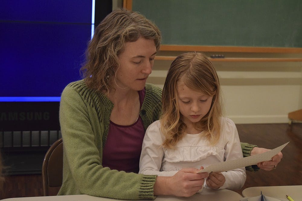 Members of the community make crafts during Winterfest on Sunday afternoon at Mathers Museum.
