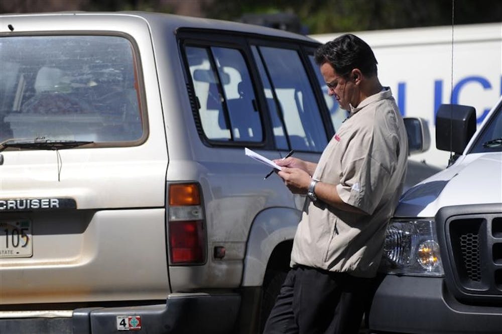 IU coach Tom Crean reads a document Tuesday in the parking lot of the Lahaina (Hawaii) Civic Center, the site of the EA SPORTS Maui Invitational. Earlier in the day, Crean's Hoosiers fell 80-54 to Saint Joseph's in the second round of the tournament.