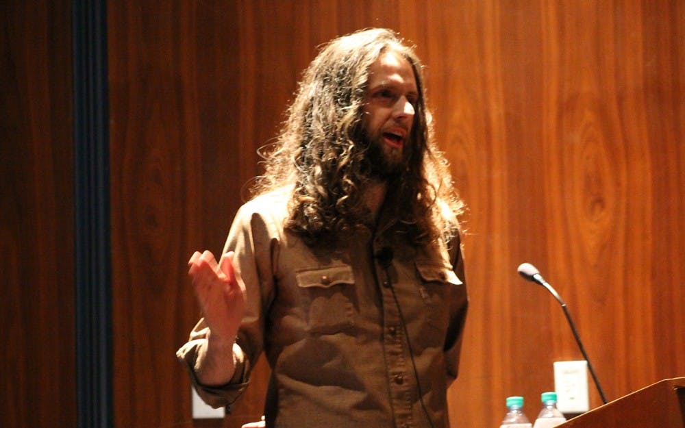 Matt Hunzinger speaks to students and staff Wednesday night. Hunzinger is a staff writer with The Onion. 
