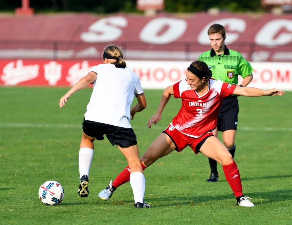 <p>Junior forward Abby Allen tries to steal the ball from a Cincinnati player during an exhibition match at Bill Armstrong Stadium on August 11. Cincinnati defeated IU, 3-1.</p>