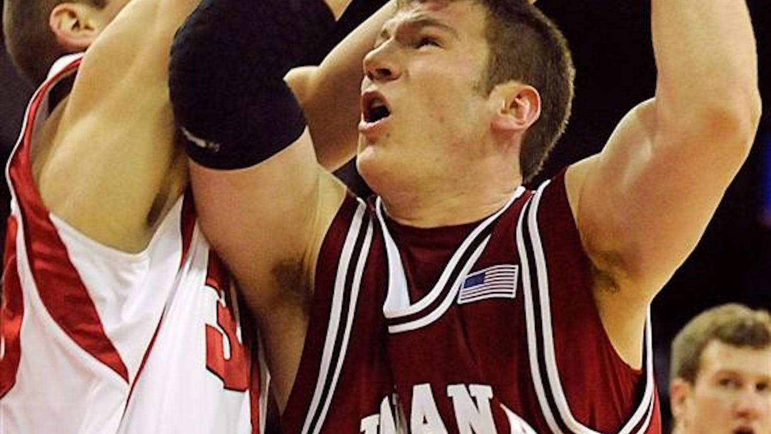 IU freshman forward Tom Pritchard is fouled by a Wisconsin defender Sunday at the Kohl Center in Madison, Wisc. Pritchard had eight points in IU's 85-61 loss.