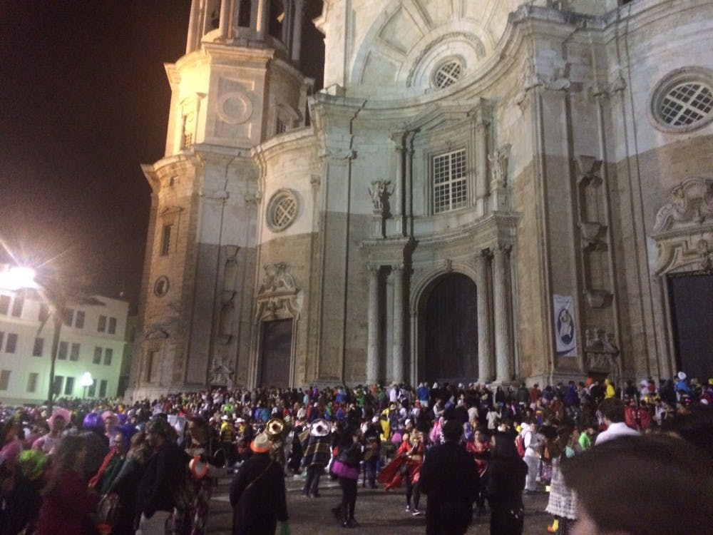 People enjoy carnaval in the main plaza in Cadiz in front of the catedral. 