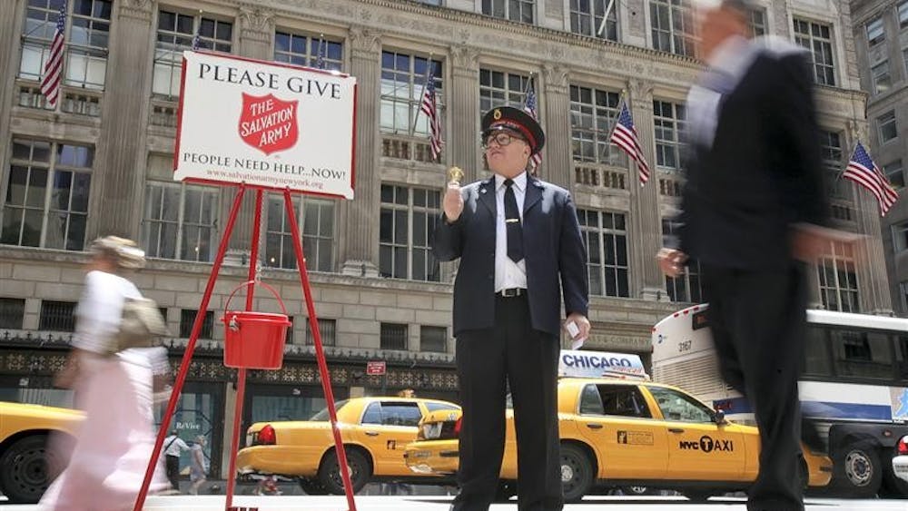 Salvation Army Soldier Daniel Aherns collects donations on 5th Ave. at Rockefeller Center, Monday, July 13, 2009 in New York. The Salvation Army's iconic red kettles and bell ringers are returning early to New York City's steamy streets to help those hardest hit by the recession.