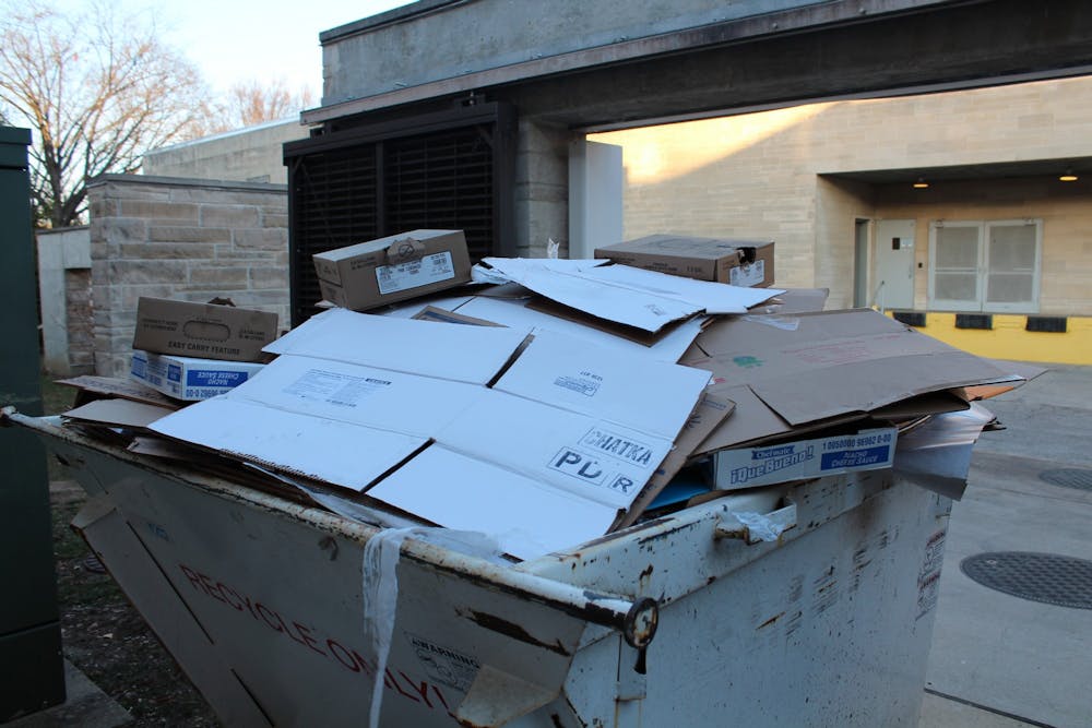 <p>Cardboard material is thrown into a separate dumpster for recyclables only outside of the Wright Quad dining hall on Feb. 20, 2023. According to Protect IU, IU-Bloomington produces 45 tons of hazardous waste. </p>