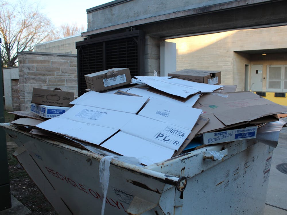 Cardboard material is thrown into a separate dumpster for recyclables only outside of the Wright Quad dining hall on Feb. 20, 2023. According to Protect IU, IU-Bloomington produces 45 tons of hazardous waste. 