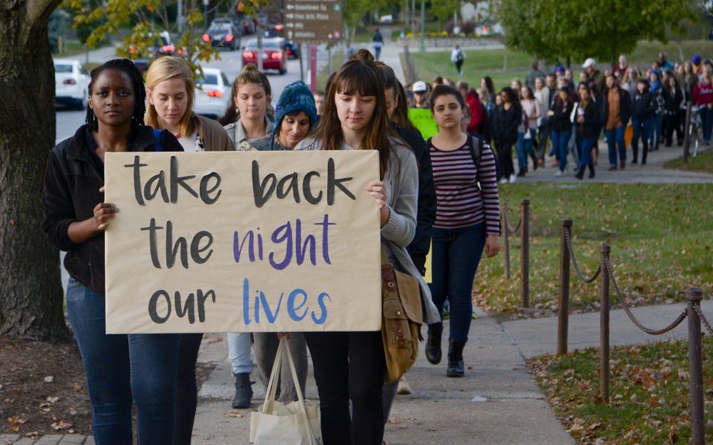 Students and community members march against sexual assault and violence and walk down to courthouse from Dunn Meadow on Thursday evening.