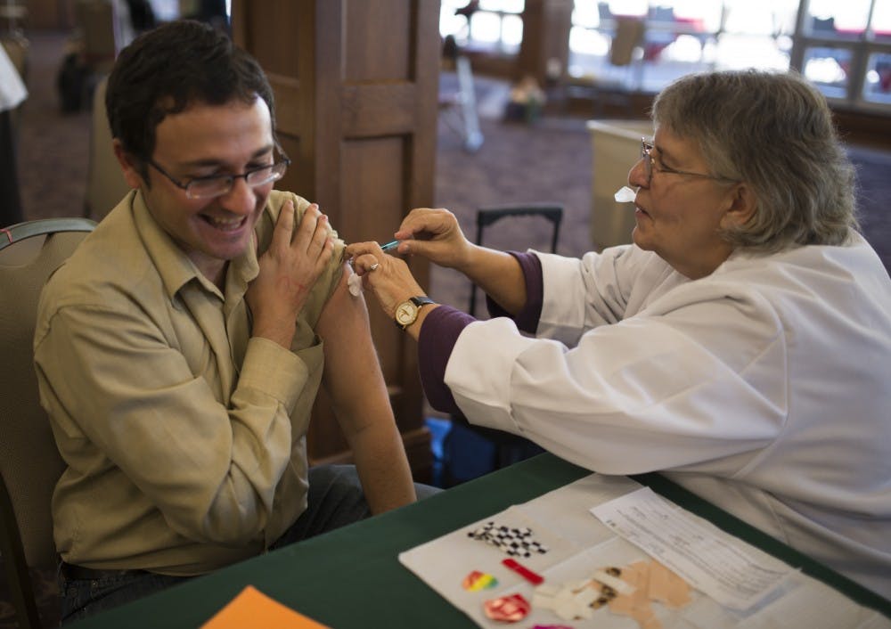 Miguel Marquez gets his flu shot at the Health Fair in 2013 at the Indiana Memorial Union.