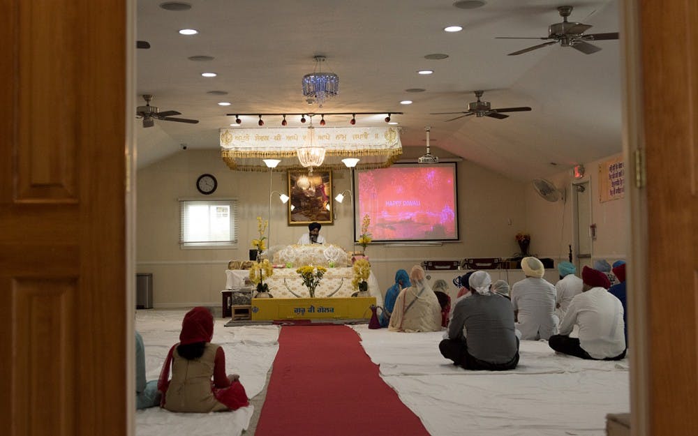 Sikhism practitioners in Fishers, Ind. attending a weekly religious ceremony where words from the Guru Granth Sahib are read. The Holy Book contains passages from the Quran and from the Old Testament. 