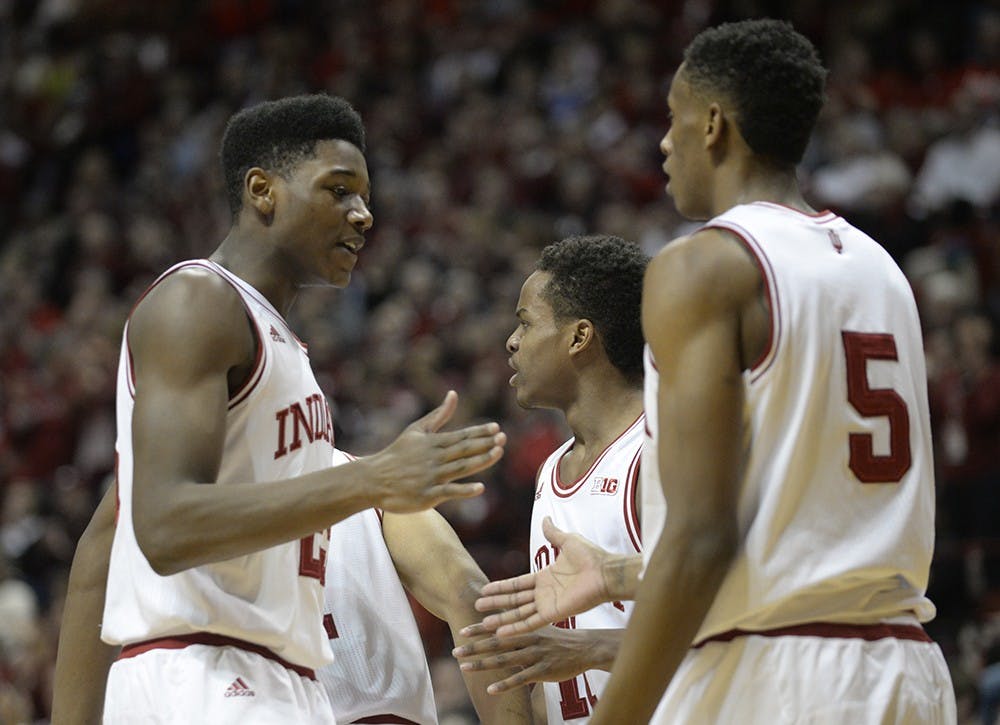 Freshman Emmitt Holt celebrates with Troy Williams after Williams dunked the ball in IU's game against Penn State on Tuesday.