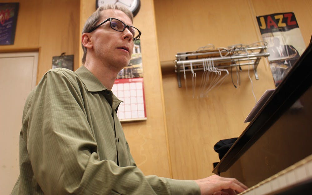Luke Gillespie plays piano during the rehearsal last night, while listening to his fellow bandmates notes.