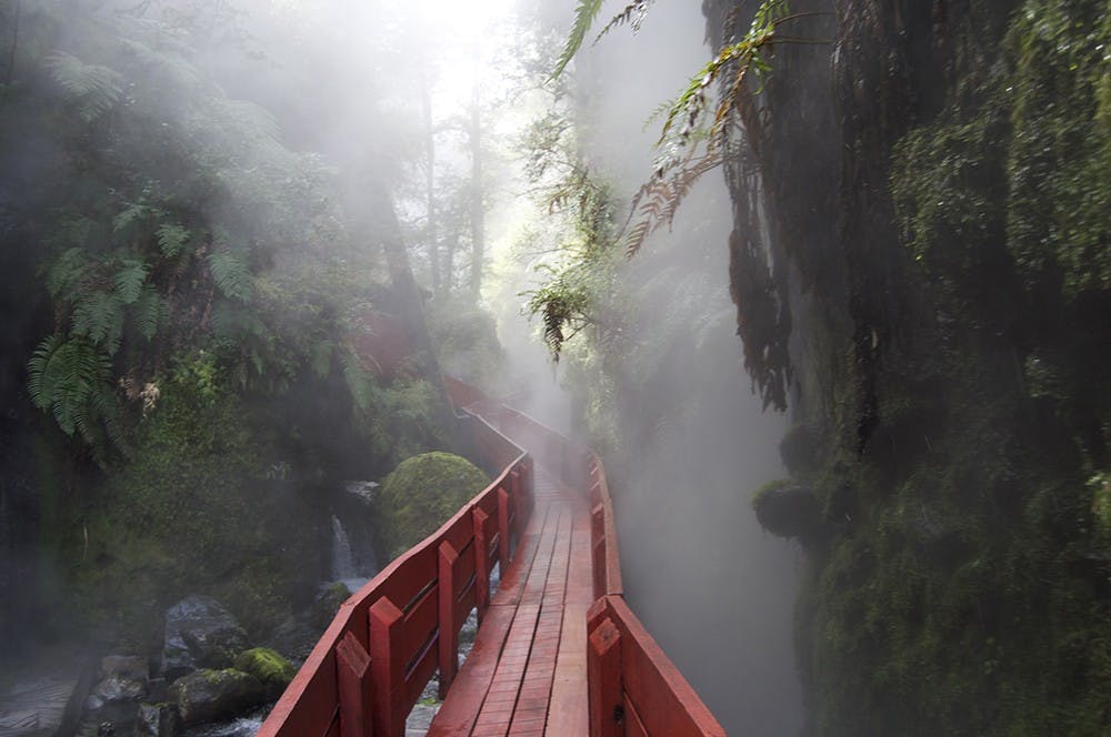  A red, wooden walkway leads visitors to the different pools the Hot Springs has to offer, and at the end of the walkway a waterfall greets viewers eyes. Though the pools are hot, the waterfall and small river that run through the area are ice cold.