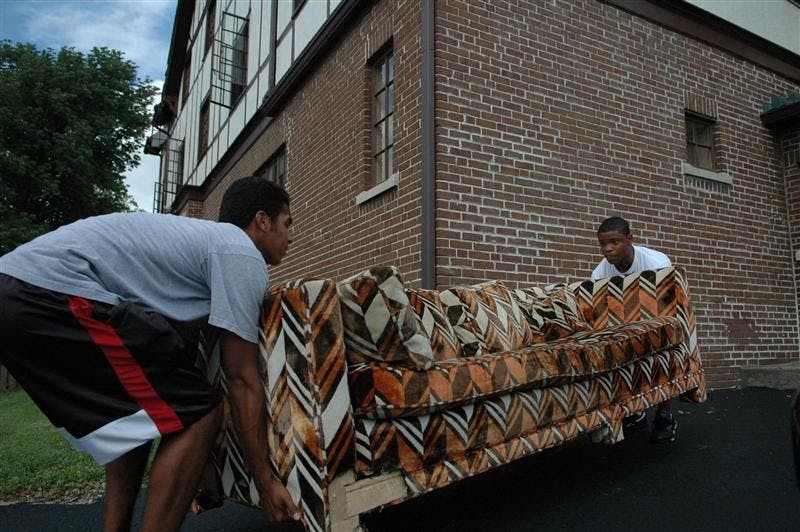 IU sophomore pledges Tim Hightower and Matthew Cole carry a couch they just bought for $185.00 on Monday afternoon into Alpha Tau Omega Fraternity on Third St.  
