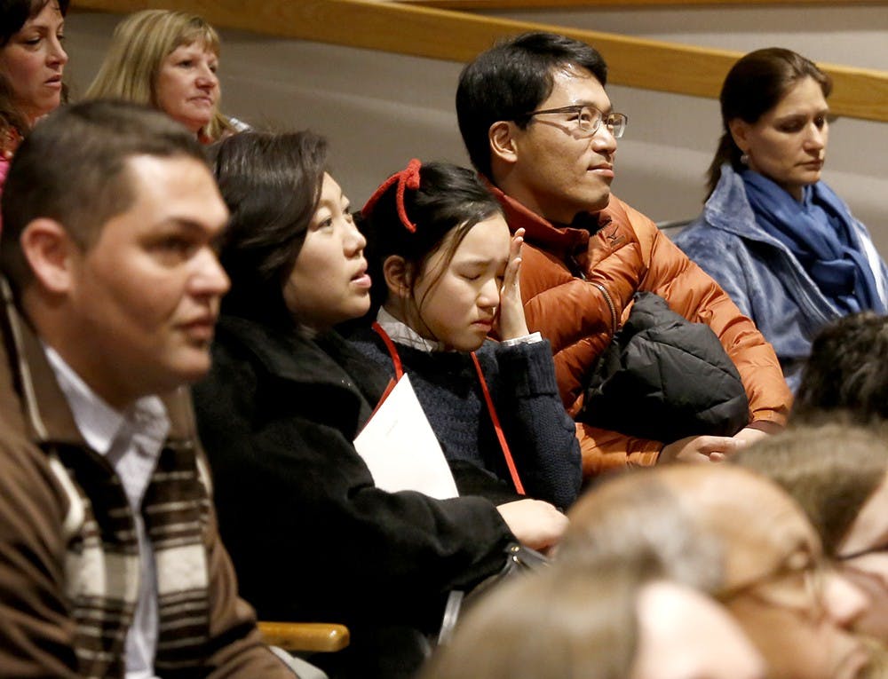 Minju Kim, center, 5th grade at Binford Elementary School, sobs after falling off after third round of the IU Spelling Bee Competition Saturday at Monroe County Public Library Auditorium. The IU Media School and The Iu School of Education hosted the event. 