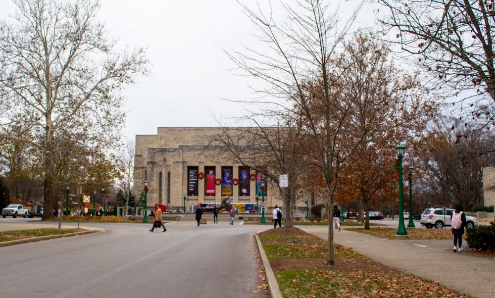 <p>Students walk on Dec. 7, 2021, along East Seventh Street in front of the IU Auditorium. IU Auditorium is accepting donations for the Hoosier Hills Food Bank during holiday season performances.</p>