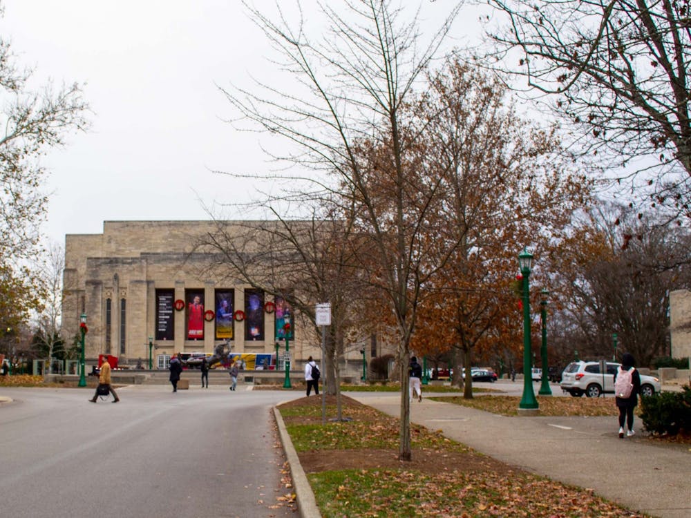 Students walk on Dec. 7, 2021, along East Seventh Street in front of the IU Auditorium. IU Auditorium is accepting donations for the Hoosier Hills Food Bank during holiday season performances.