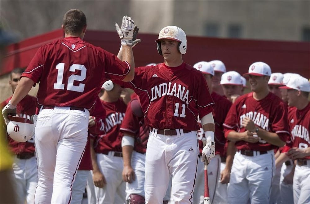 IU left fielder now sophomore Alex Dickerson is congratulated by teammates after hitting a home run during IU's 26-6 win against Michigan April 6 at Sembower Field.