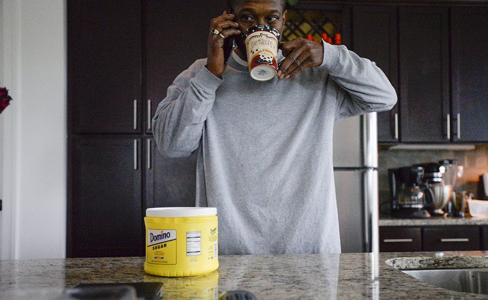 Jeffrey stands in his kitchen in Indianapolis, drinking 2 cups of Folger's coffee before starting his day.