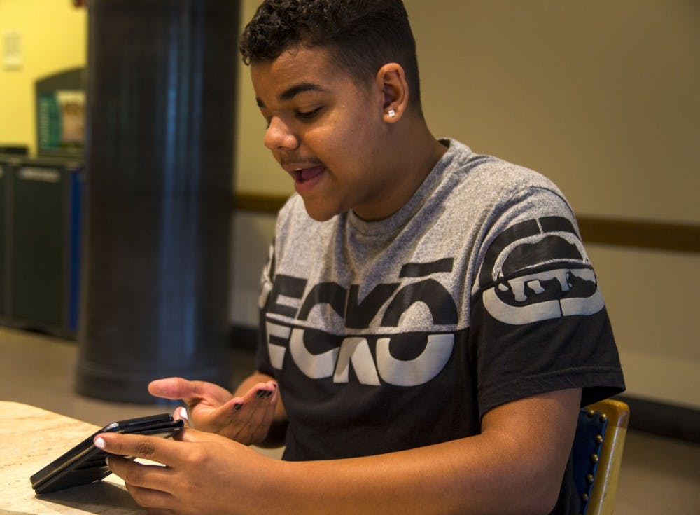 <p>Freshman Kamaron Farver pulls up a list of things that went wrong for his first week of classes at IU on Sept. 2 at Wright Quad. Farver accidentally went into a classroom on the third floor of Ballantine Hall when he was supposed to be on the second floor.</p>
