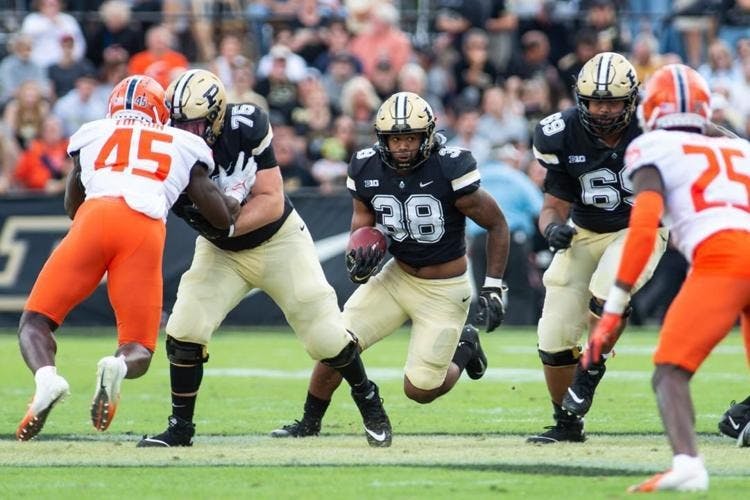 Sophomore left guard Spencer Holstege and graduate student left tackle Greg Long clear a path for redshirt freshman running back Dylan Downing.