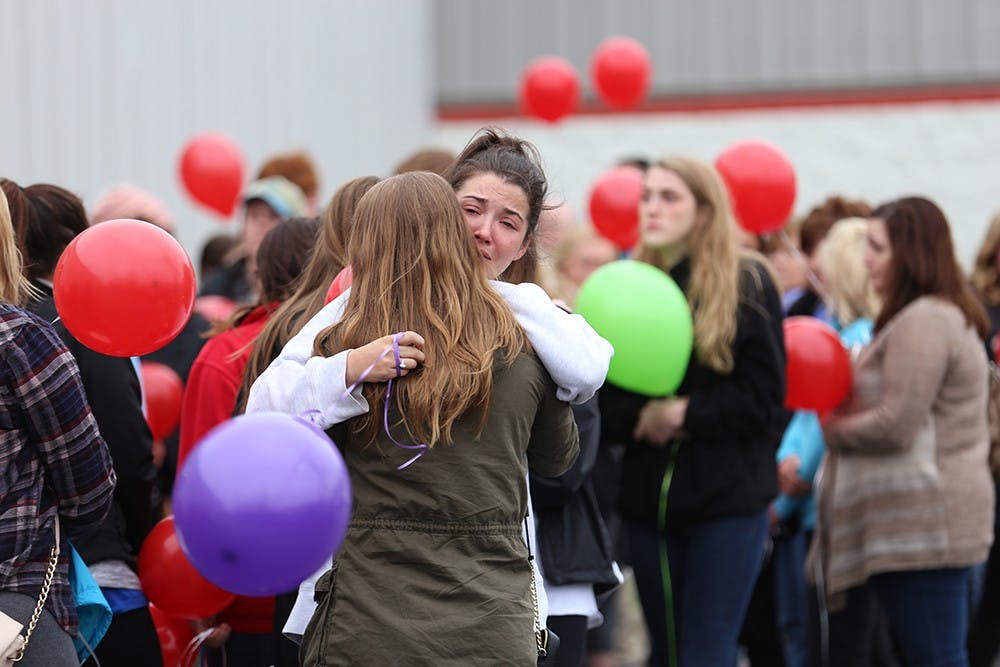 Hundreds gather to mourn the loss of Hannah Wilson, IU senior murdered Friday morning, outside Indiana Elite Cheer & Tumbling in Noblesville, Ind. on Saturday afternoon. Wilson, a Fishers, Ind. native who used to cheer at Indiana Elite, was a psychology major and a sister in the Gamma Phi Beta sorority at IU. 
