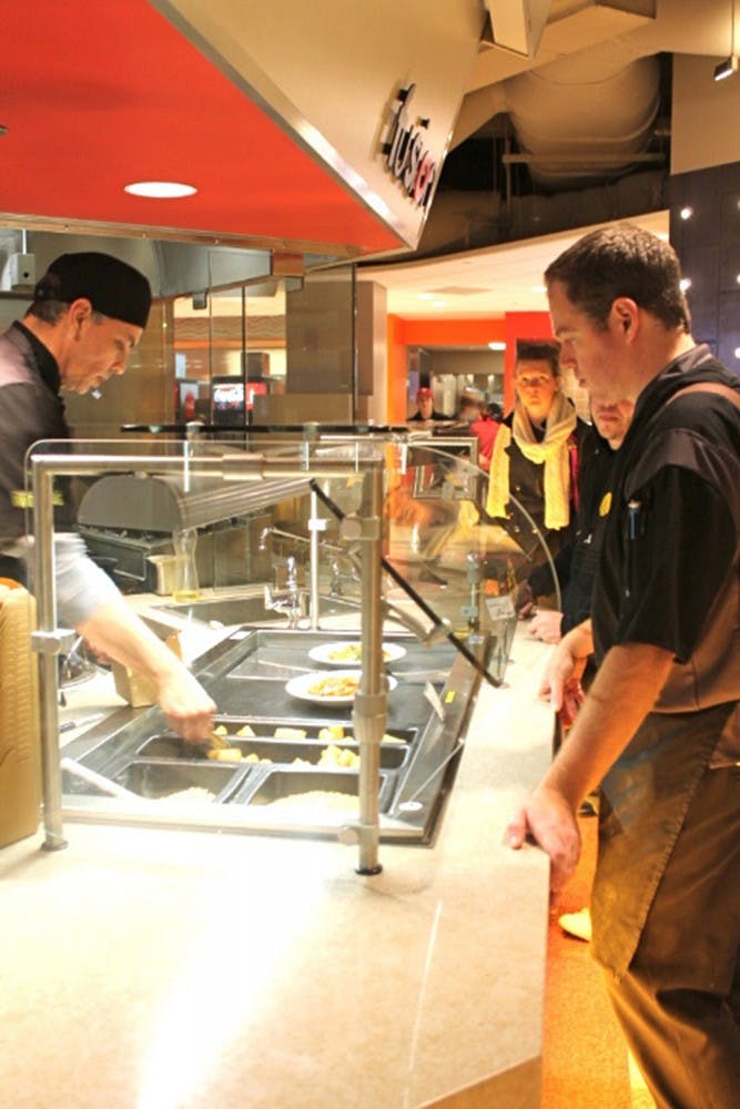 Students line up at Fusion on Tuesday at Woodlands Dining Hall in Forest Quad. The restaurant provides a range of international cuisine from Chinese to Korean to Ethiopian.