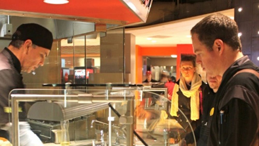 Students line up at Fusion on Tuesday at Woodlands Dining Hall in Forest Quad. The restaurant provides a range of international cuisine from Chinese to Korean to Ethiopian.