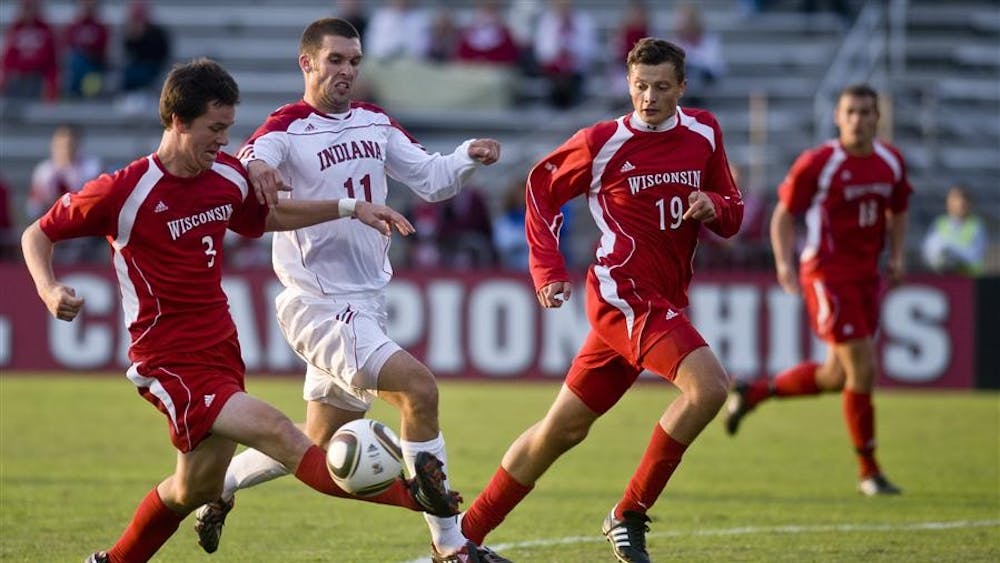 Wisconsin's Kyle McCrudden clears the ball away from junior forward Will Bruin during IU's 1-1 draw against the Badgers on Oct. 3 at Bill Armstrong Stadium.