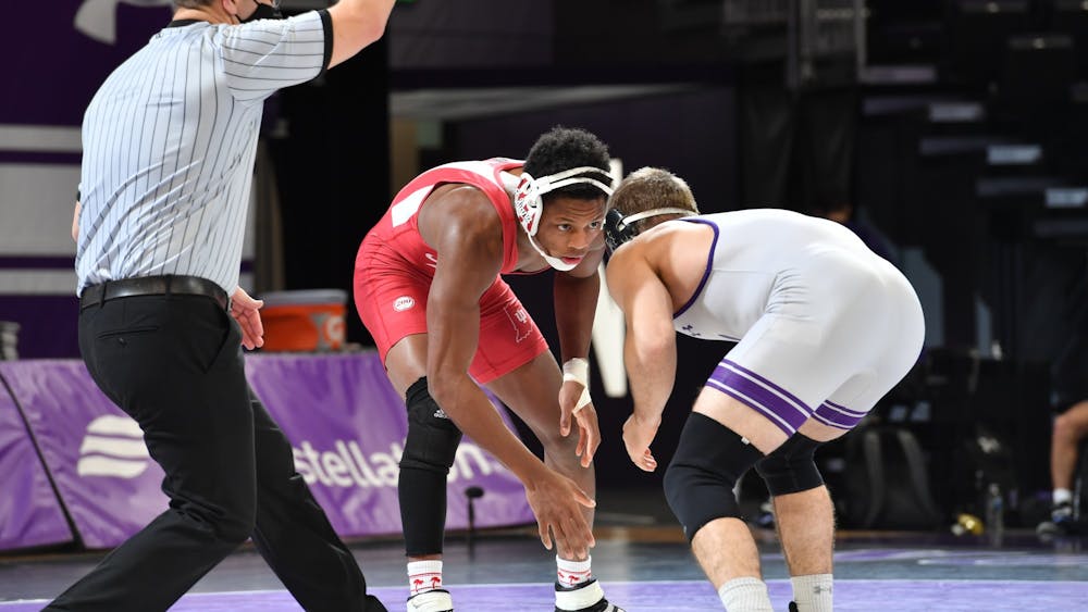 Sophomore DJ Washington stares down Northwestern redshirt freshman Troy Fisher during their match Jan. 30. Washington was named Big Ten Wrestler of the Week after pinning Fisher and defeating No. 5 redshirt freshman Carter Starocci from Penn State on Saturday. 