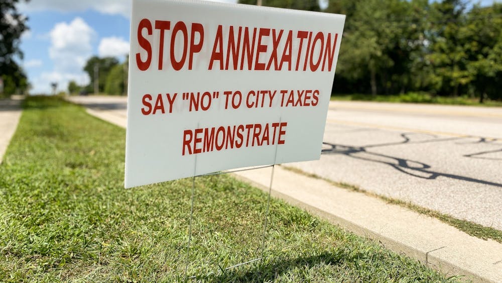 A &quot;Stop Annexation&quot; sign appears Aug. 23, 2021, on West﻿ Vernal Pike. When developers added city sewer service to a neighborhood, county residents who lived there waived their rights to protest annexation by signing petitions.  