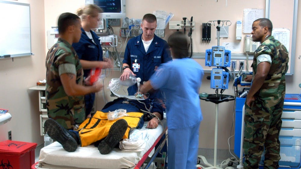 040703-N-9362D-003Guantanamo Bay, Cuba (July 3, 2004) - U.S. Naval Hospital, Guantanamo Bay (Gitmo) staff participates in an emergency room training exercise to ensure immediate and accurate treatment during an actual casualty. U.S. Navy photo by Photographer