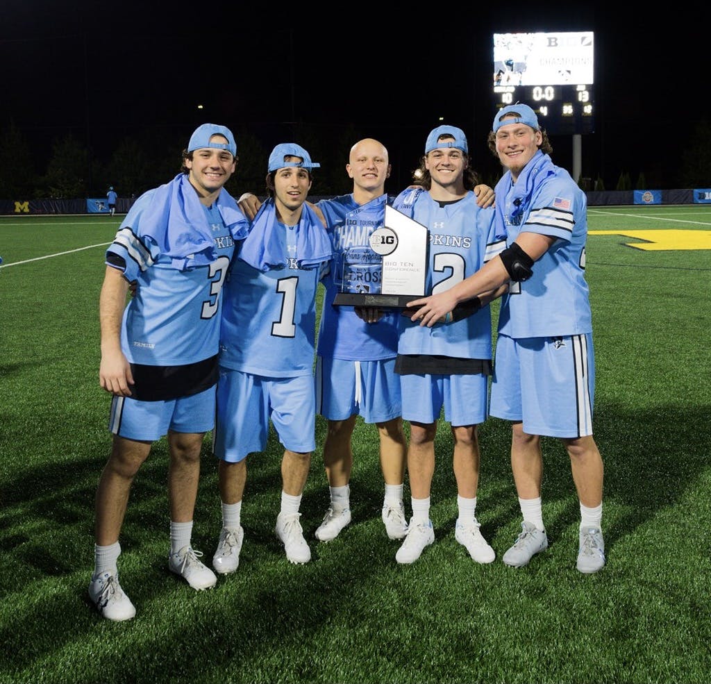 COURTESY OF HOPKINSSPORTS.COM
DeSimone (left) celebrates the 2018 Big 10 Championship victory over Maryland