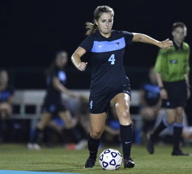  HOPKINSSPORTS.COM
Senior Issy Berkey dribbles the ball
as the Lady Jays celebrate Senior Day