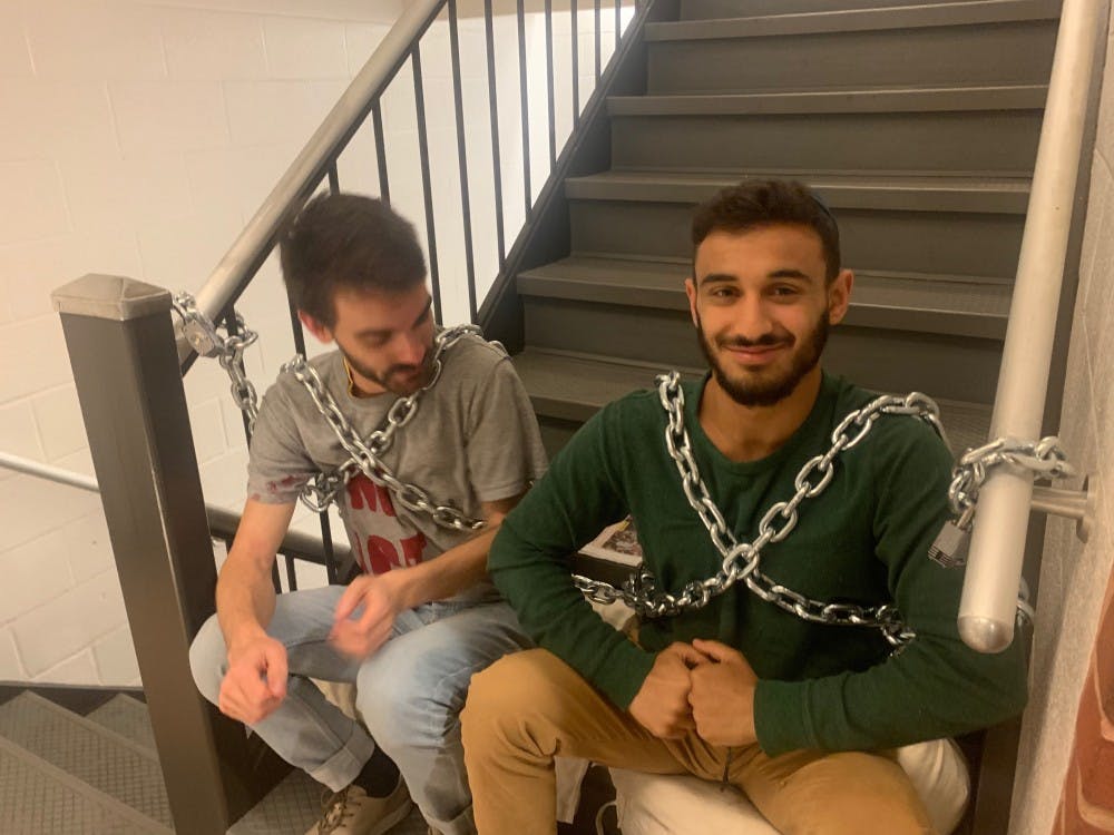 Protesters prevent access to the second and third floors by chaining themselves to the staircase.
