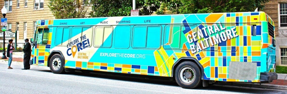 COURTESY OF EXPLORE THE CORE! CENTRAL BALTIMORE
The new stickers on the JHMI buses advertise the Homewood Community Partners Initiative’s campaign to invest in Baltimore.