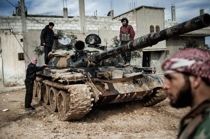 Members of the Free Syrian Army commandeer a tank from government forces in the western city of Al-Qusayr in March 2012. Courtesy of FLICKR.COM/SYRIAFREEDOM 