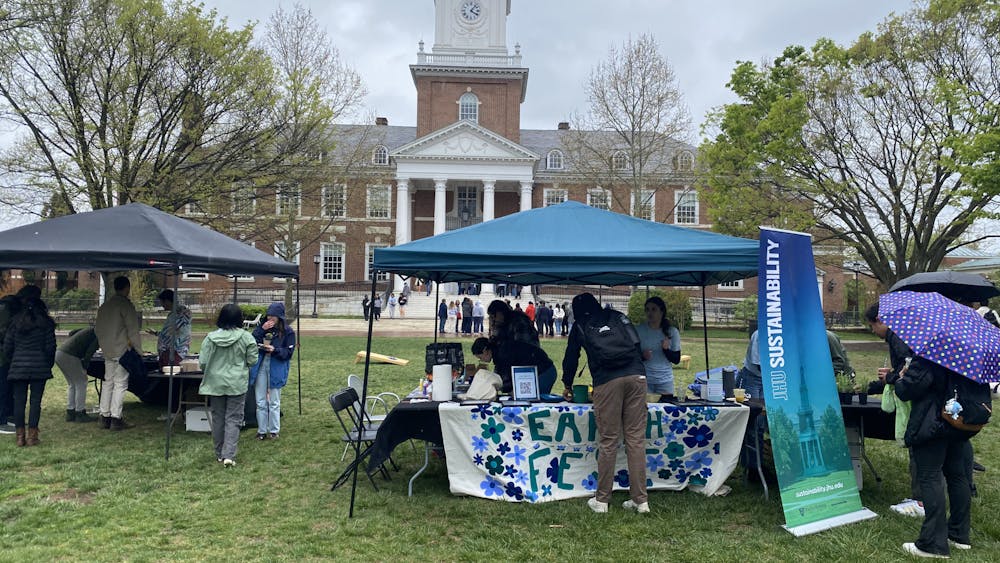 COURTESY OF NICK DAUM
Student gathered to participate in Earth Fest. Offerings included free plants, food and smoothies, which were blended by pedaling on a bike. 