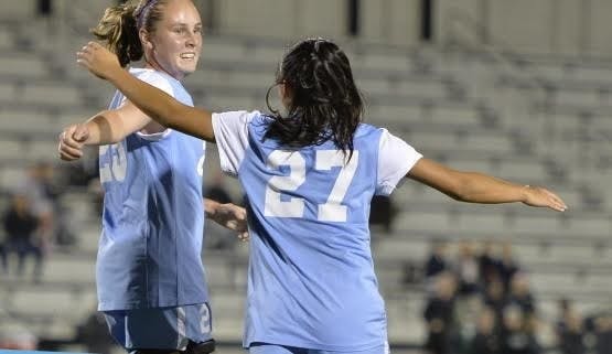 HOPKINSSPORTS.COM
Freshman Kristen Hori (27) celebrates with her teammate on Oct. 17.